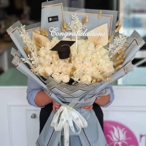 Hand Bouquet With White Roses And Dried Leaves