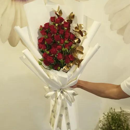 Hand Bouquet With Red Baby Roses And Gold Leaves