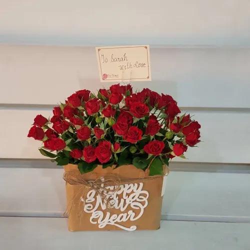 Small Floral Bag Arrangement With Red Baby Roses