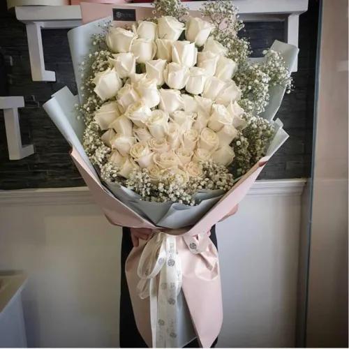 Hand Bouquet With White Gypsophila And White Roses