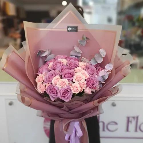 Hand Bouquet With Purple Roses And Pink Baby Roses And Purple Leaves