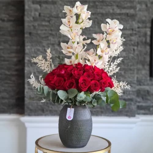 Black Translucent Vase With Red Roses And Orchids