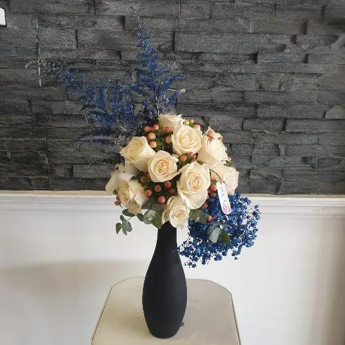 Black Vase With White And Blue Flowers