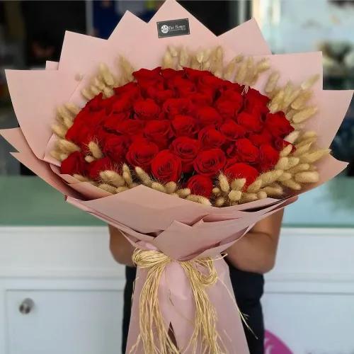 Hand Bouquet With Red Roses And Bunny Hair