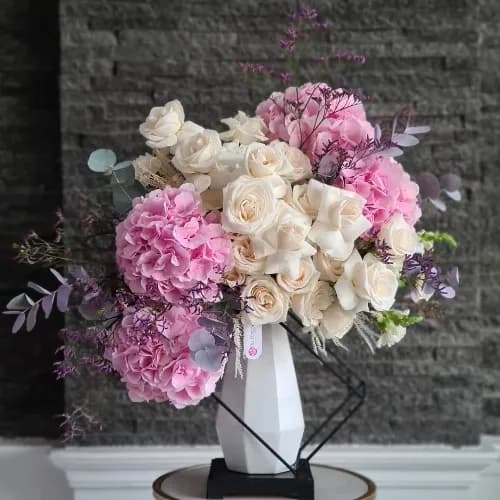 White Ceramic Vase With Pink And White Flowers