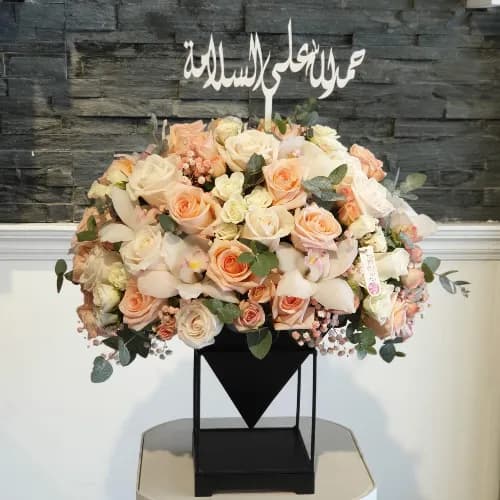 Black Stand With Peach And White Flowers