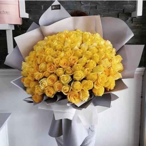 Hand Bouquet With Yellow Roses In Grey/white Paper Wrapping