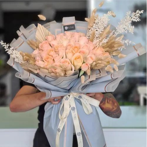 Hand Bouquet With Peach Roses And Dried Leaves