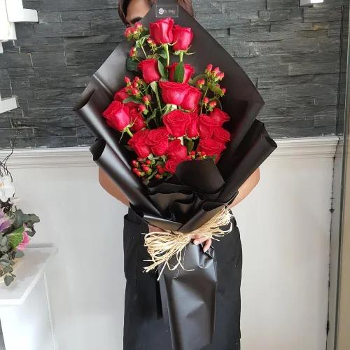 Hand Bouquet With Red Roses And Red Hypericum