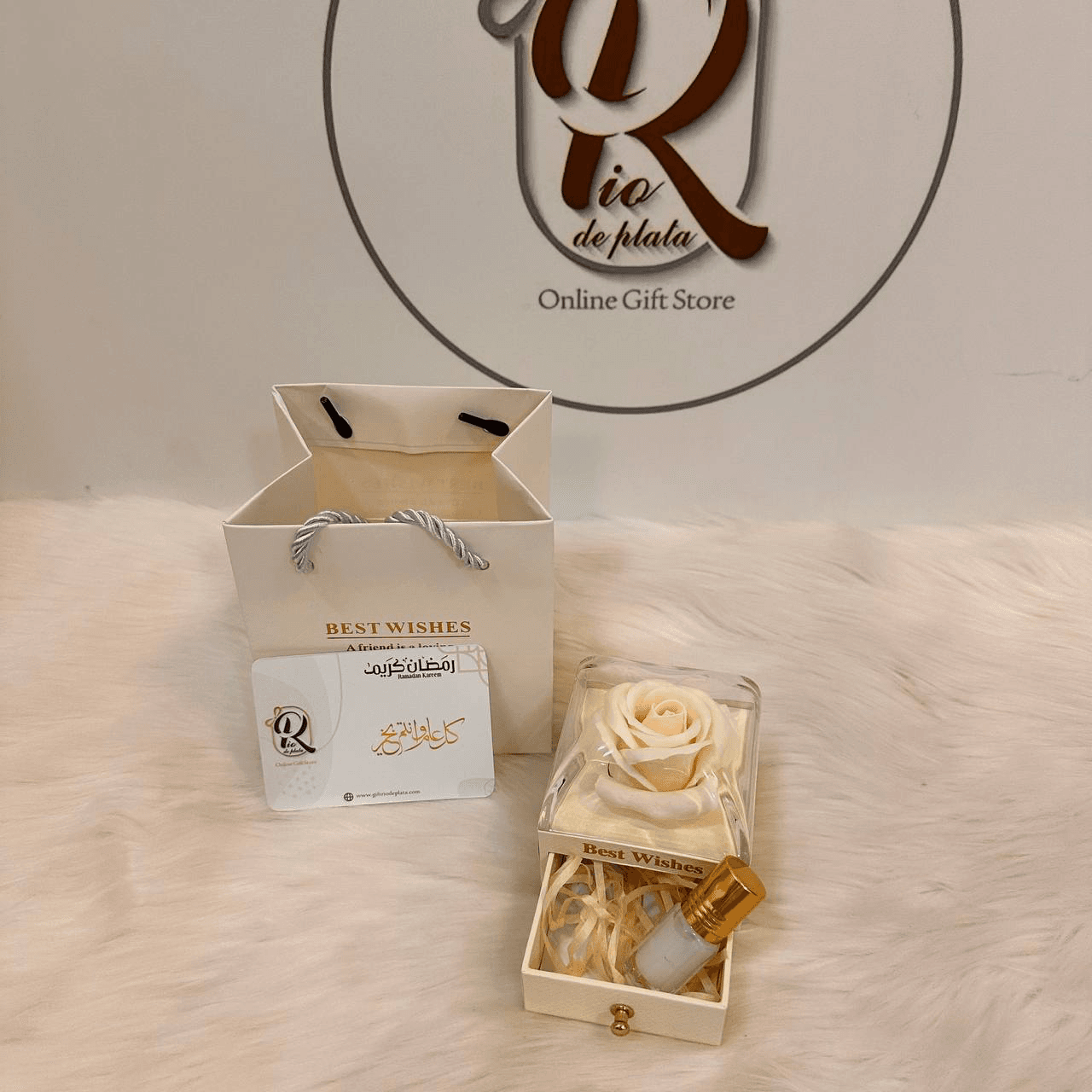 Ramadan gift distributions, a box of white roses with musk perfume inside, with a Ramadan Mubarak card.