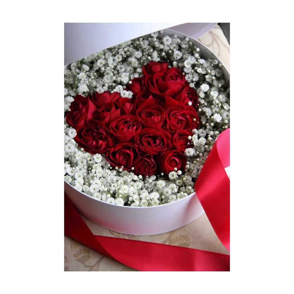 A White Box Full Of Red Roses And Gypsophillia